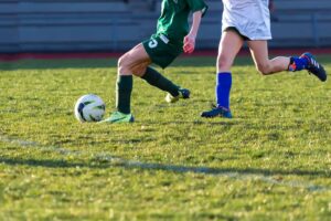 soccer player running with the ball