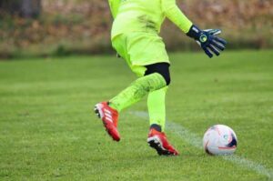 soccer goalkeeper in a green color jersey