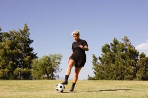 Person Playing Soccer On The Field