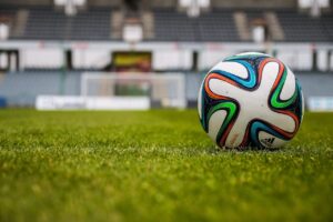 White Adidas Soccer Ball on Green Field