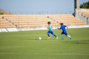 Young Boys Running while Playing soccer