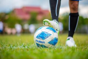 man leg on a soccer ball