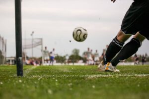 player kicks on a football