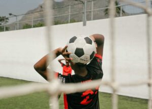 soccer player holding a ball