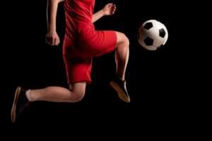 soccer player kicking a ball