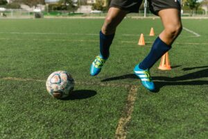 soccer player kicking a ball